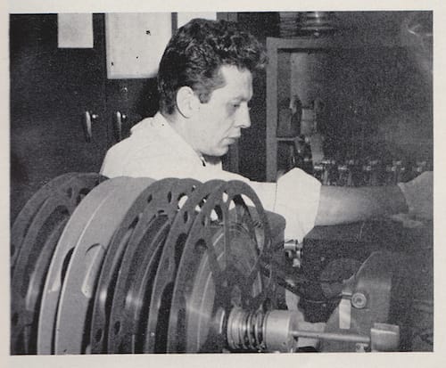 "Director Frank Diaz edits completed works prints of a wrestling shoot: three reels house film from three separate cameras along with a magnetic sound track. To effect perfect sound-motion sequence, all four films must be kept in sync during editing. 